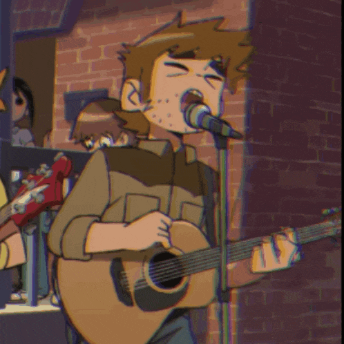 a man singing into a microphone while holding a guitar
