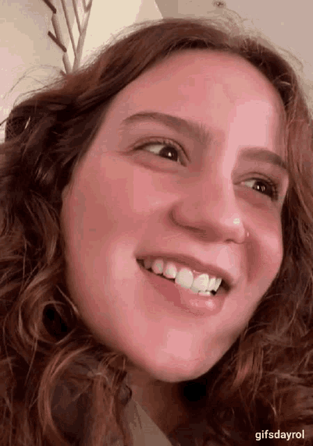 a close up of a woman 's face with the words gifsdayrol below her