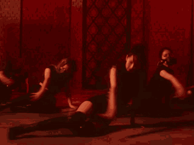 a group of people are dancing in a dark room