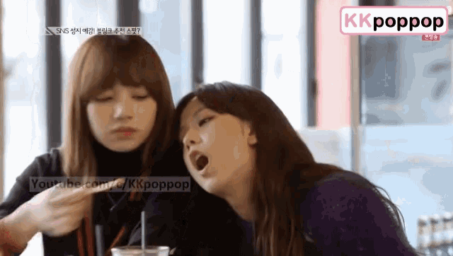 two girls are sitting next to each other with a youtube.com icon in the corner