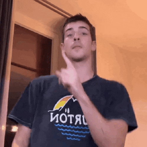 a man wearing a t-shirt with the word motel on it is making a funny face .
