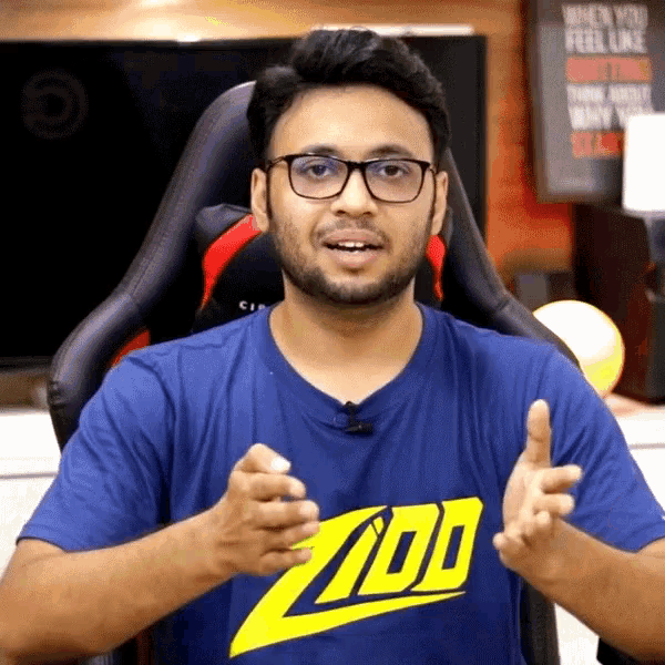 a man wearing glasses and a blue shirt that says zoo on it
