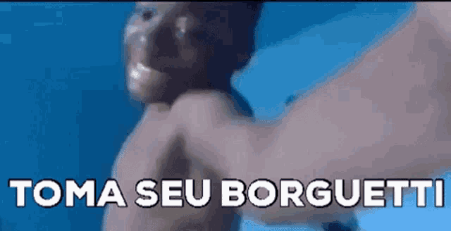 a man without a shirt is swimming in the ocean with the words toma seu borguetti written on the bottom .