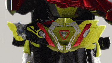 a close up of a toy with a belt that has a red and yellow triangle on it