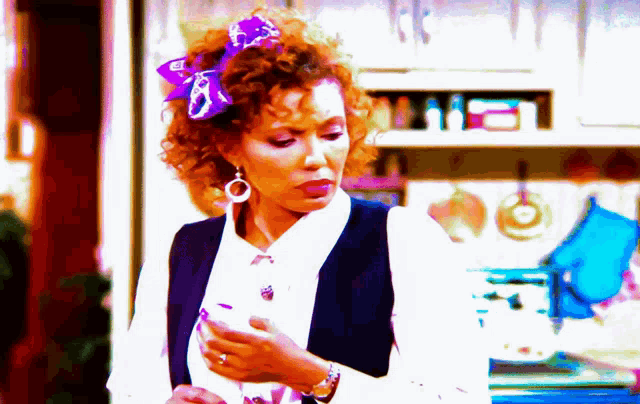 a woman with curly hair and a purple bow in her hair