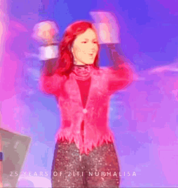 a woman in a pink jacket is standing in front of a purple background with the words 25 years of 21ti nurhalisa on it