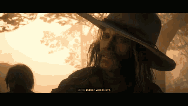 a man with long hair wearing a cowboy hat says " minah it damn well doesn't "
