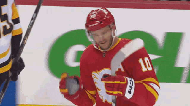 a hockey player in a red jersey with the number 10 on it
