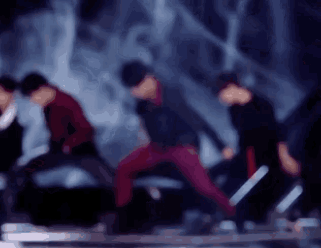 a blurry picture of a group of people dancing on stage