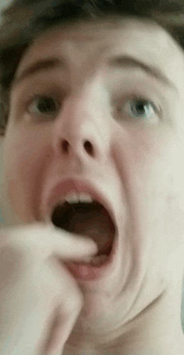 a close up of a person 's face with their mouth open