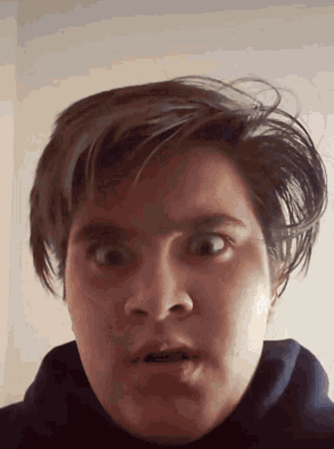 a close up of a person 's face making a funny face