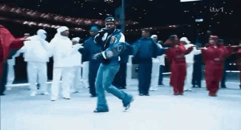 a group of people are dancing in front of a sign that says itv1 on it