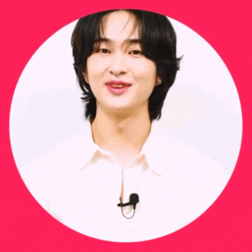 a man with a microphone around his neck is smiling in a circle