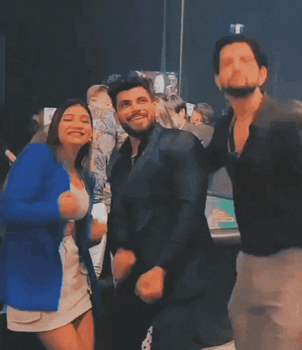 a group of people are dancing together and one of them is wearing a white skirt