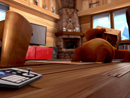 a bear with a box on its head sits on a wooden table