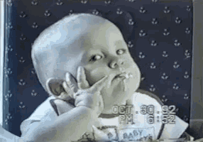 a baby is making a funny face and the time is 6:52 pm