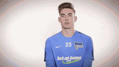 a young man wearing a blue shirt with the number 33 on it