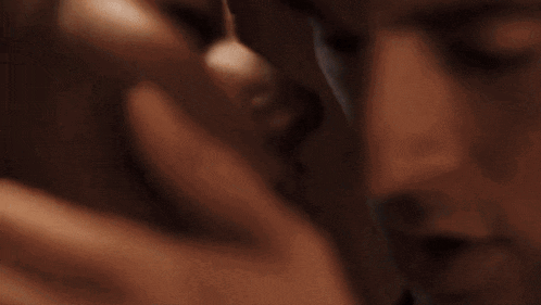 a close up of a person 's hand holding a cell phone in a dark room .