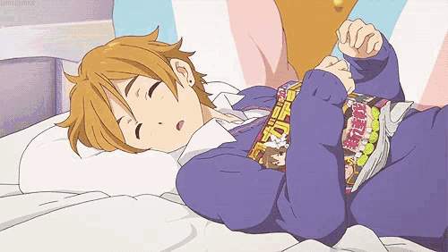 a person laying on a bed with a magazine on their shoulder that says ' tokyo ghouls ' on it