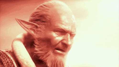 a man with a beard and elf ears has a red background