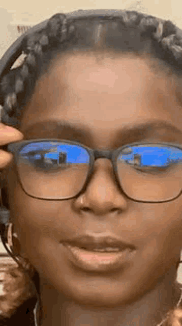 a close up of a woman wearing glasses and a headphone .