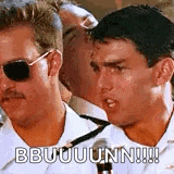 a man wearing sunglasses and a mustache is standing next to another man .