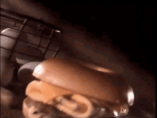 a close up of a hamburger being eaten by a person