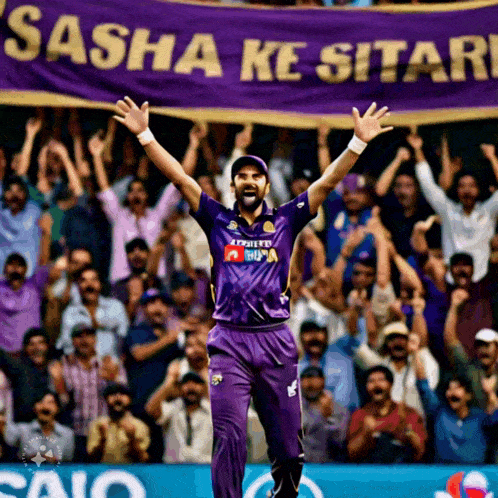 a man in a purple shirt stands in front of a banner that says sasha ke sitar