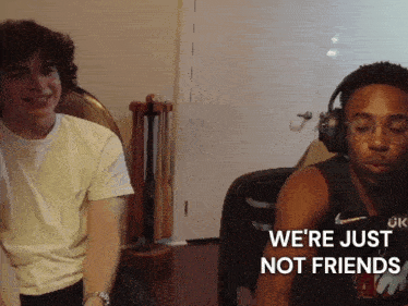 a man wearing headphones says " we 're just not friends " while sitting next to another man
