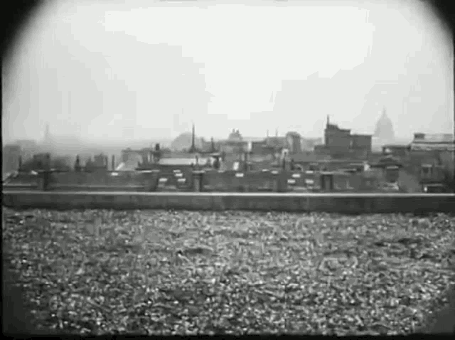 a black and white photo of a city skyline with a lot of buildings