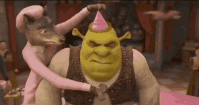 shrek is wearing a pink party hat while being held by a woman in a pink dress .