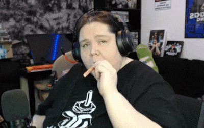 a man wearing headphones is smoking a cigarette and looking at the camera