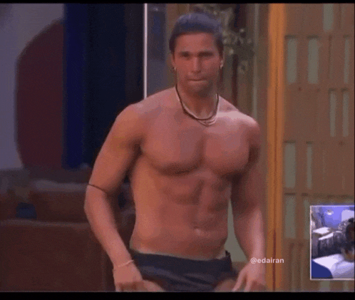 a shirtless man is standing in front of a screen that says @edairan on it