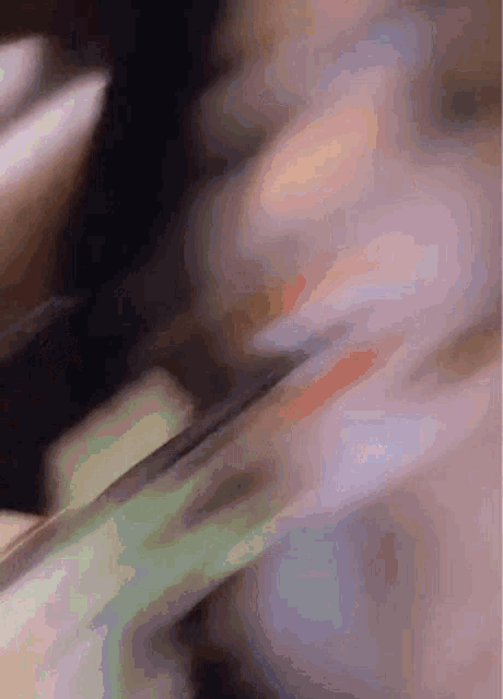 a close up of a person 's face with a blurry background and a few lines