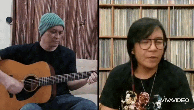 a man is playing an acoustic guitar next to a woman who is wearing glasses