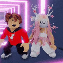 a boy in a red shirt with a dinosaur on it sits next to a girl in a pink dress