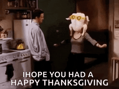a woman is holding a stuffed turkey on her head while a man stands behind her .