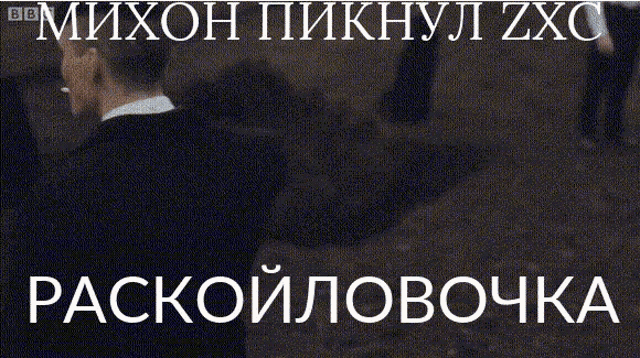 a man in a suit is smoking a cigarette with a bbc logo behind him