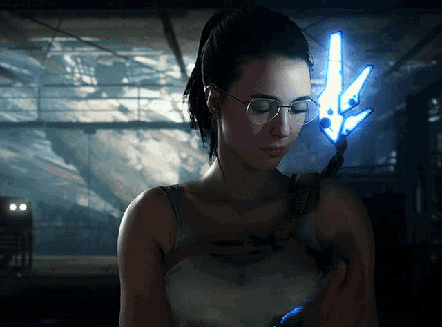 a woman wearing glasses is holding a blue light in her hand