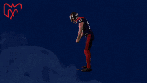 a football player with the number 15 on his jersey is dancing