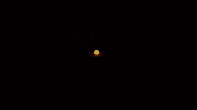 a fireworks display in the night sky with a yellow explosion