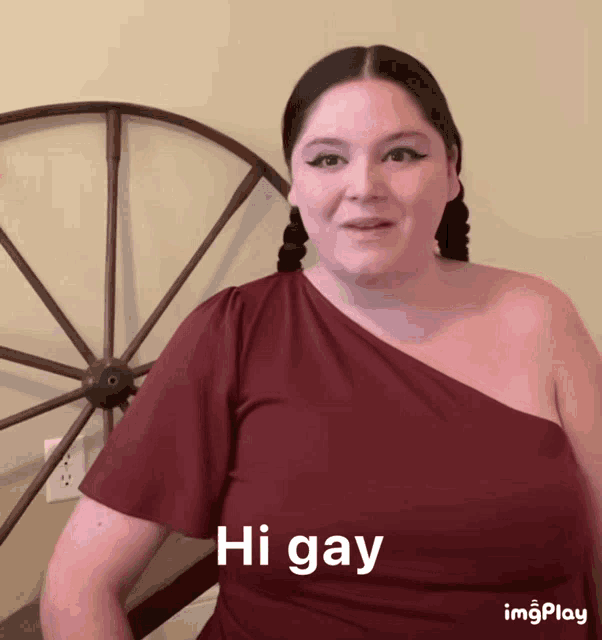a woman wearing a red shirt says hi gay