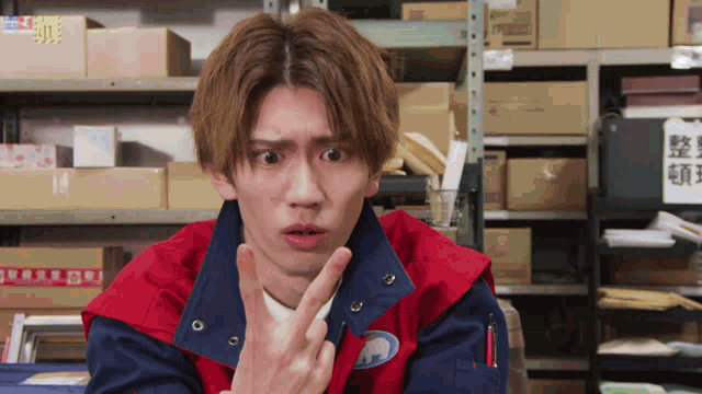 a man in a red and blue jacket making a funny face