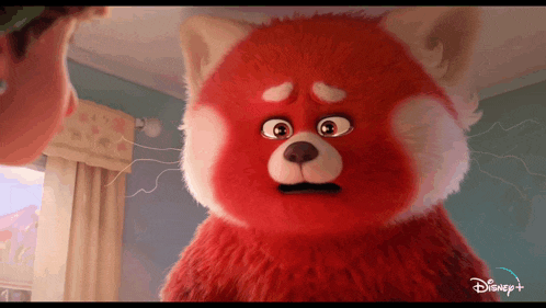 a red stuffed animal with a disney logo on it