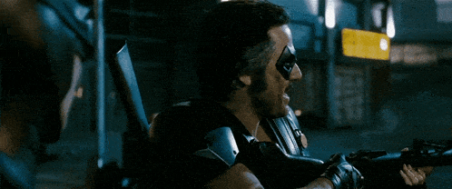 a person is holding a gun in a dark area