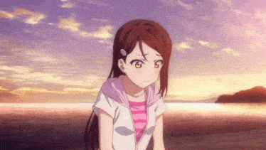 a girl with long hair is standing on a beach