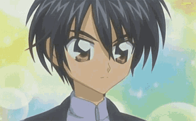 a close up of a boy 's face with a purple shirt and a black jacket