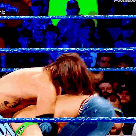 two men are wrestling in a wrestling ring with the word ethe next big thing written on the bottom