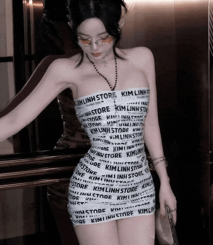 a woman wearing a strapless dress that says kimlinh store