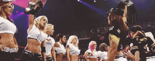 a group of cheerleaders are standing in a line with one wearing a pittsburgh steelers uniform